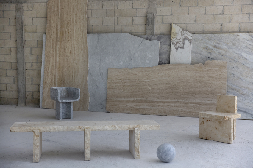 Chair 11, Bench 20 and Chair 20 in front of leaning travertine and marble slabs